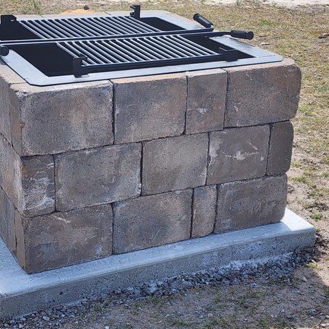A grill made out of bricks with a metal grate