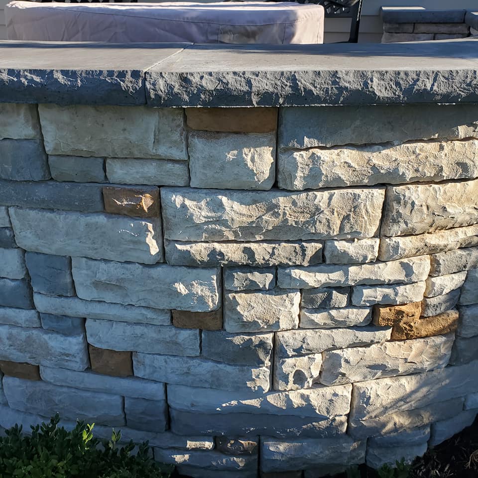 A stone wall with a few bricks missing