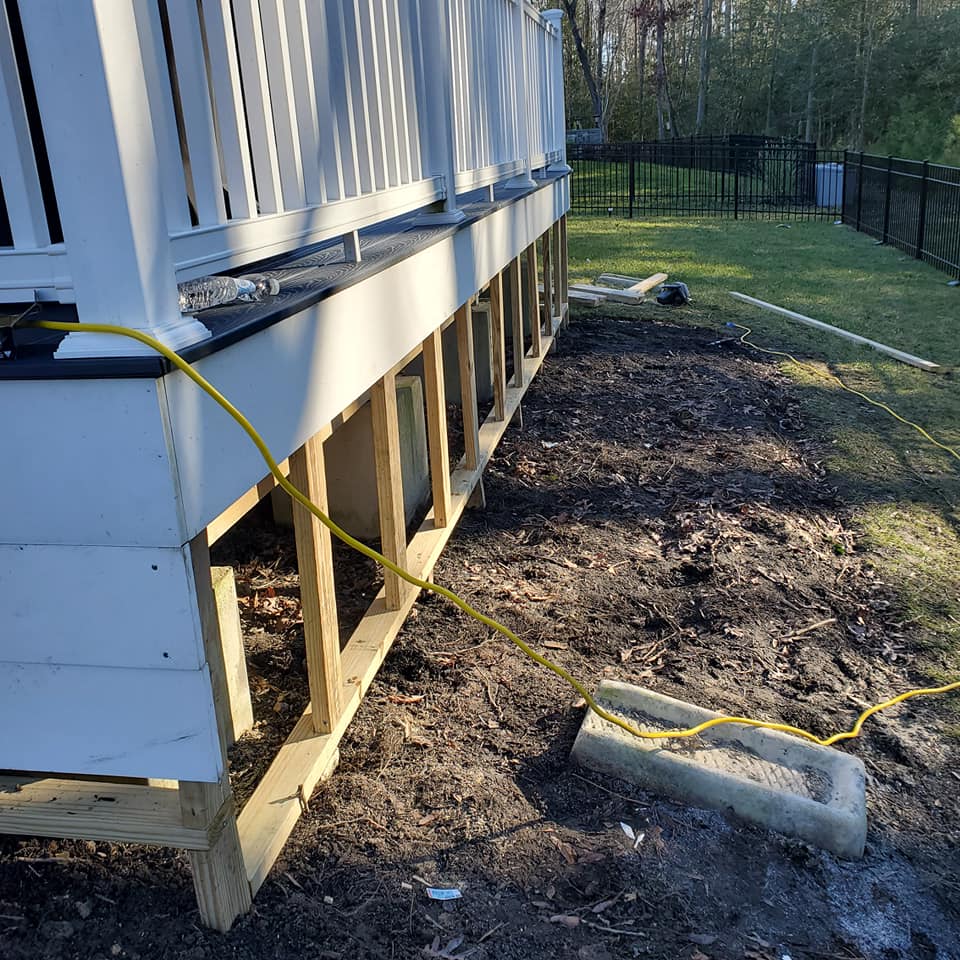 A yellow power cord is connected to the side of a house.