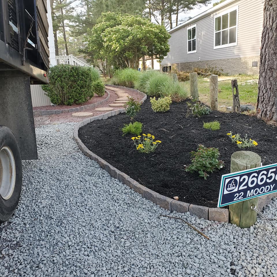 A gravel driveway with a sign that says 2658 22 moody