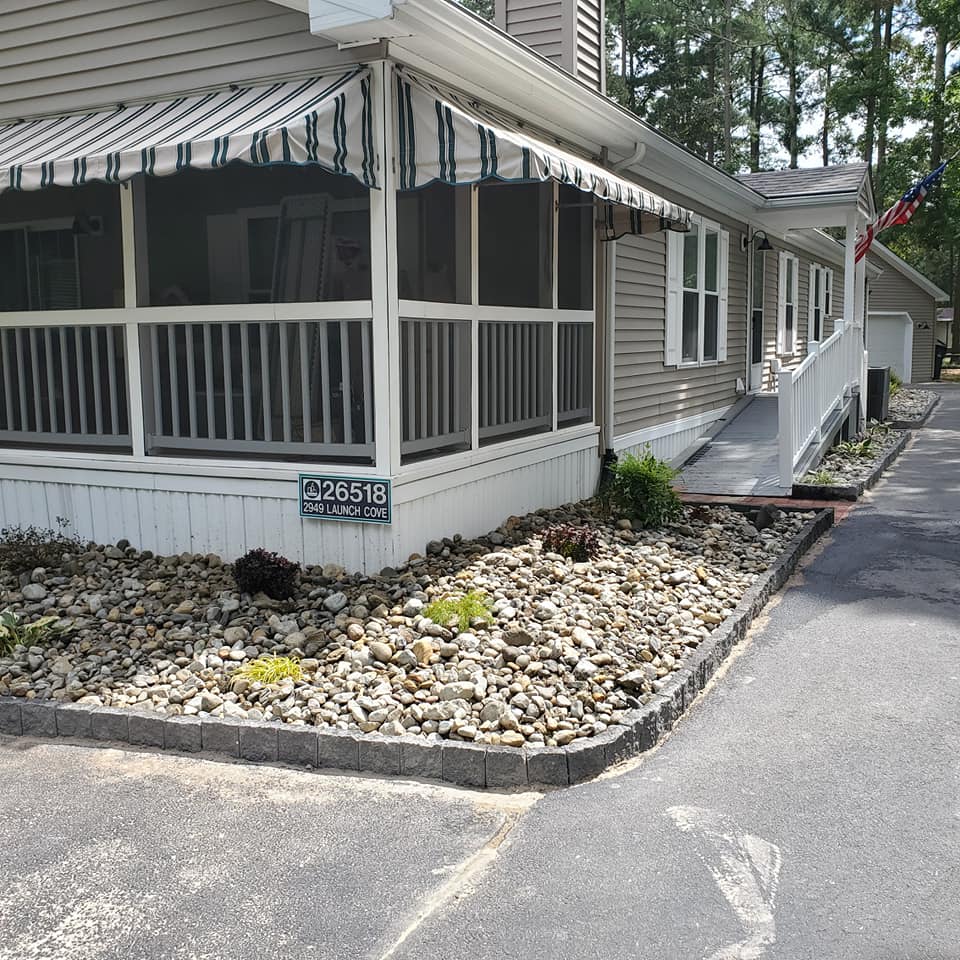 A mobile home with a screened in porch and a sign that says p26018