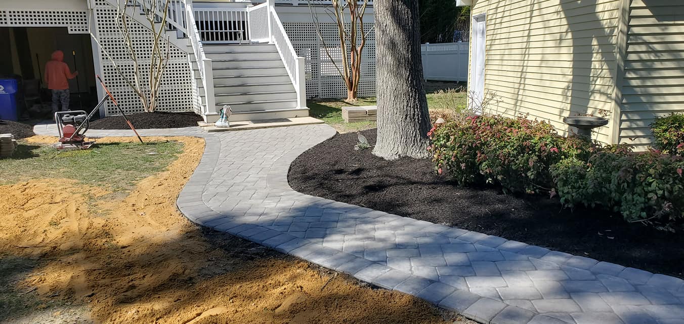 A walkway is being built in front of a house.