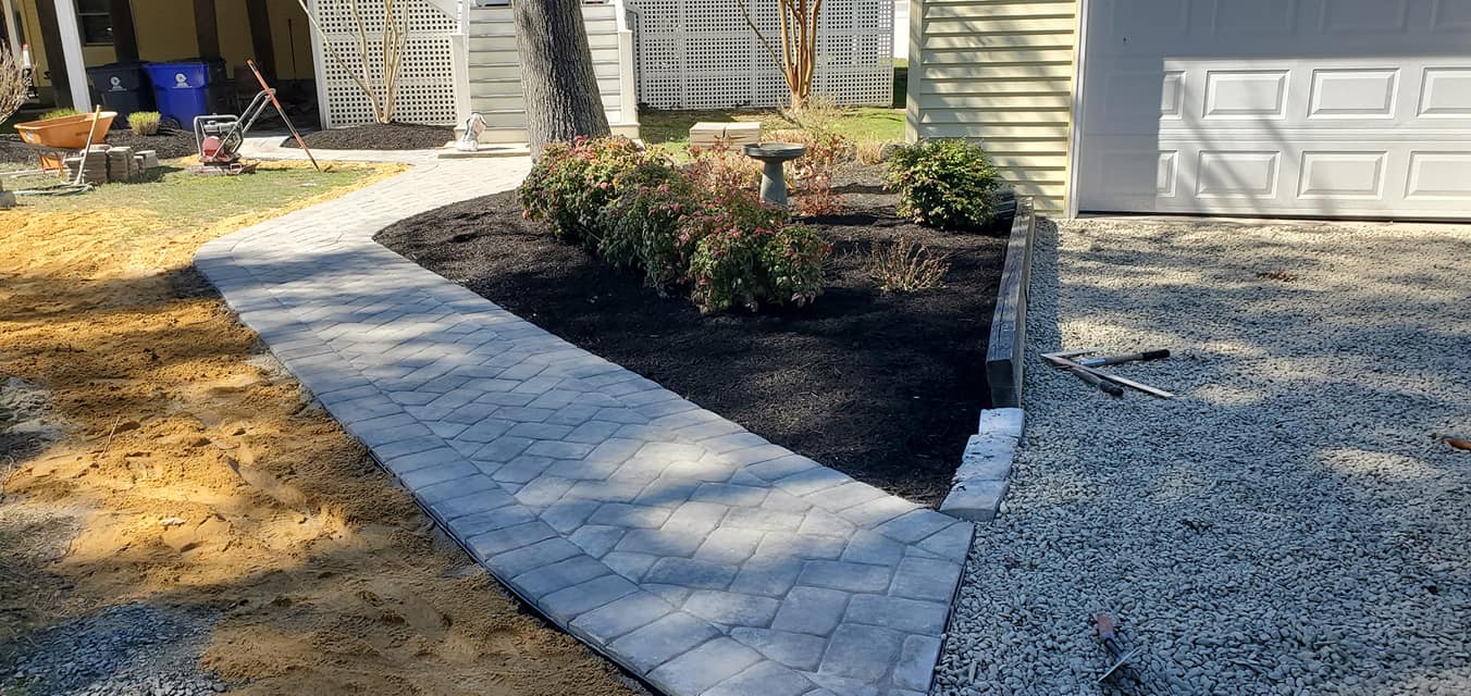 A walkway is being built in front of a house.