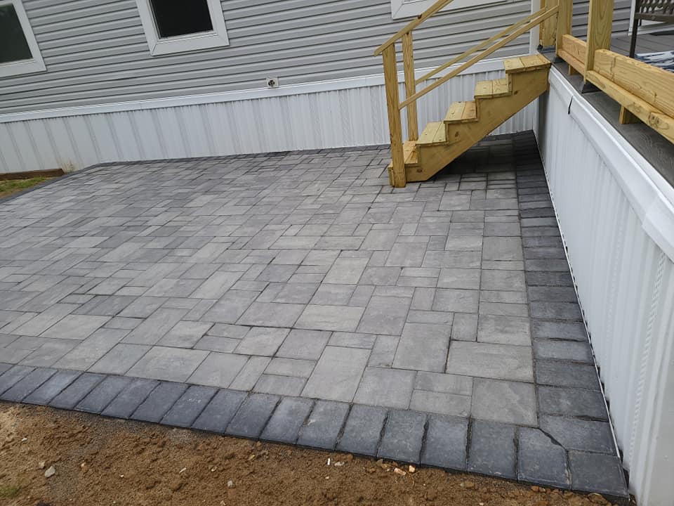 A patio with stairs leading up to a house