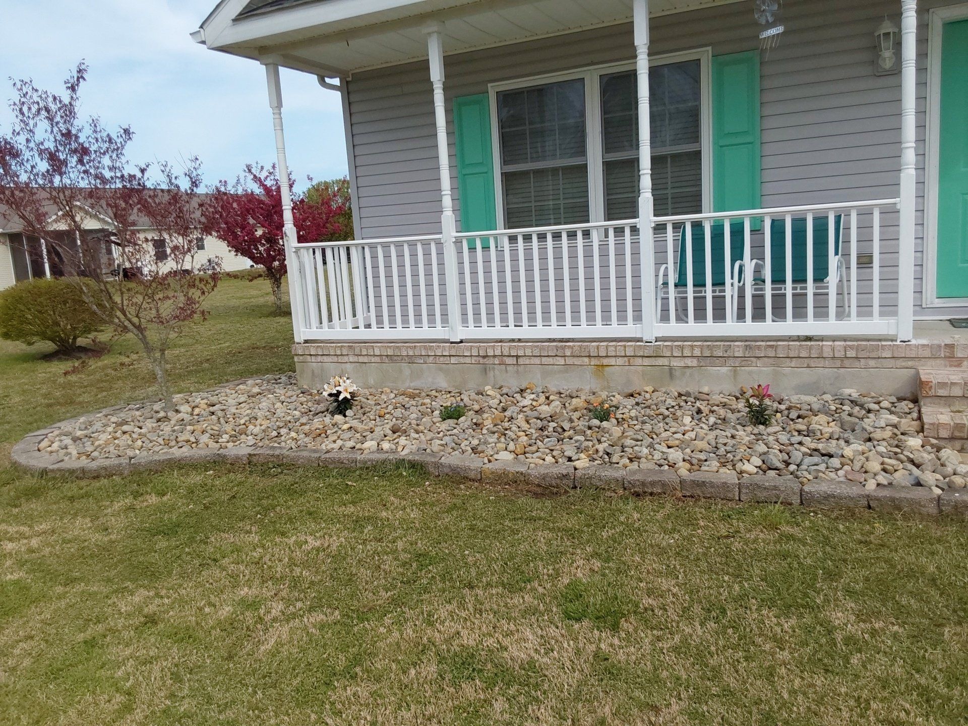A house with a porch and green shutters