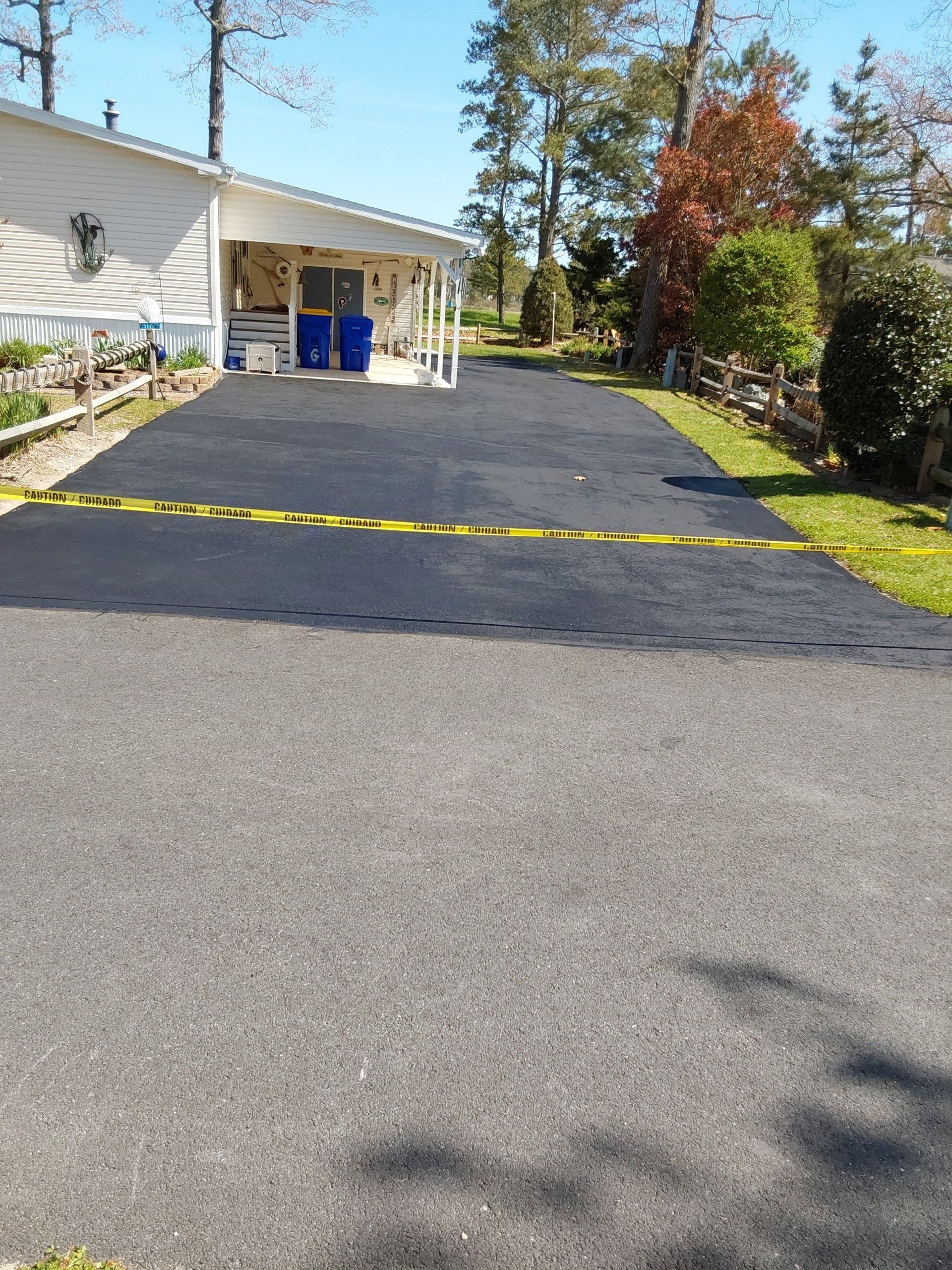 A mobile home with a black driveway leading to it