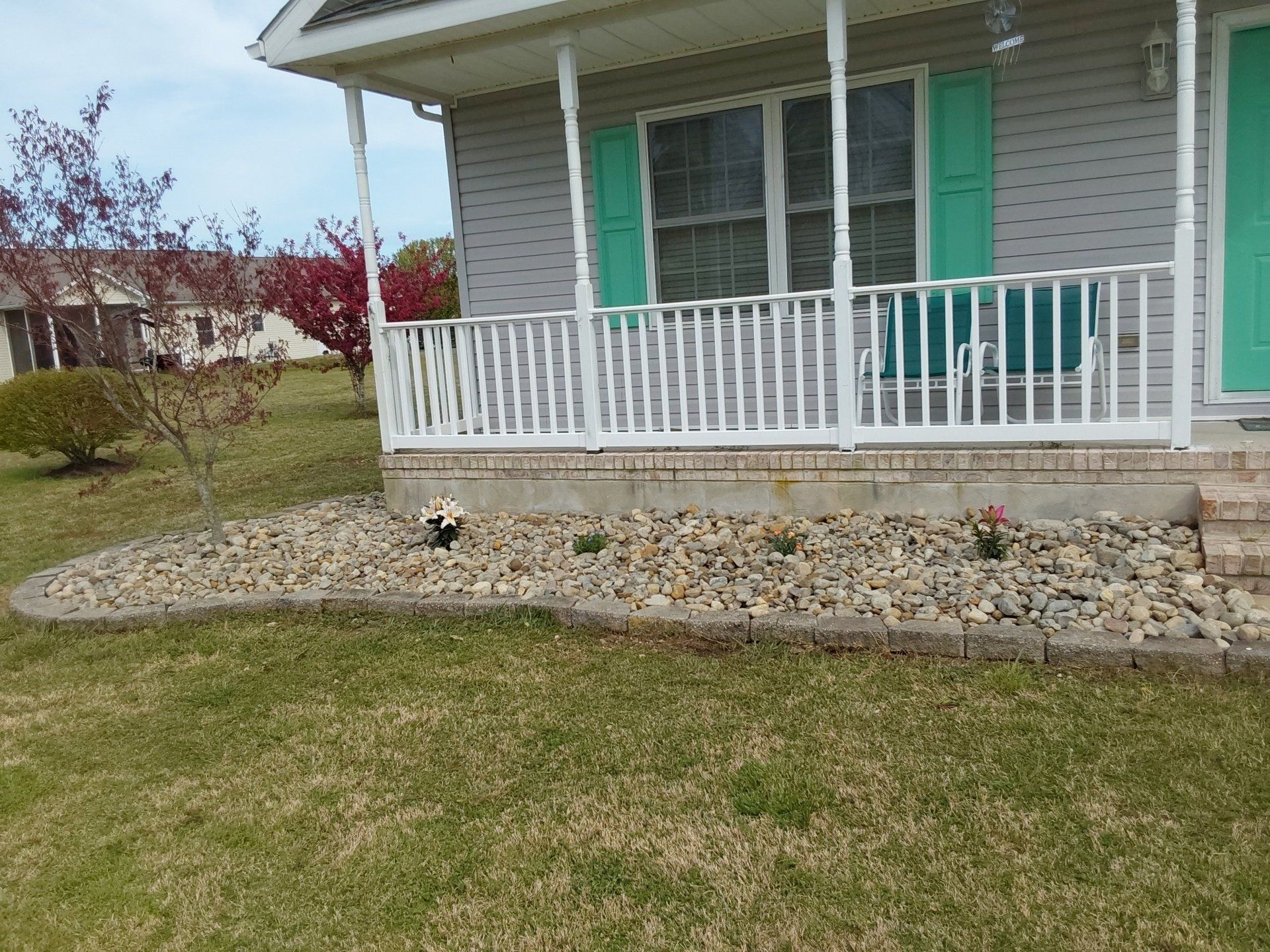 A house with a porch and green shutters
