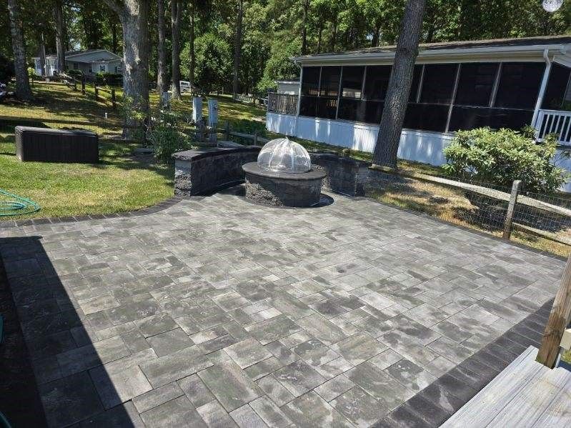 There is a fire pit in the middle of the patio.