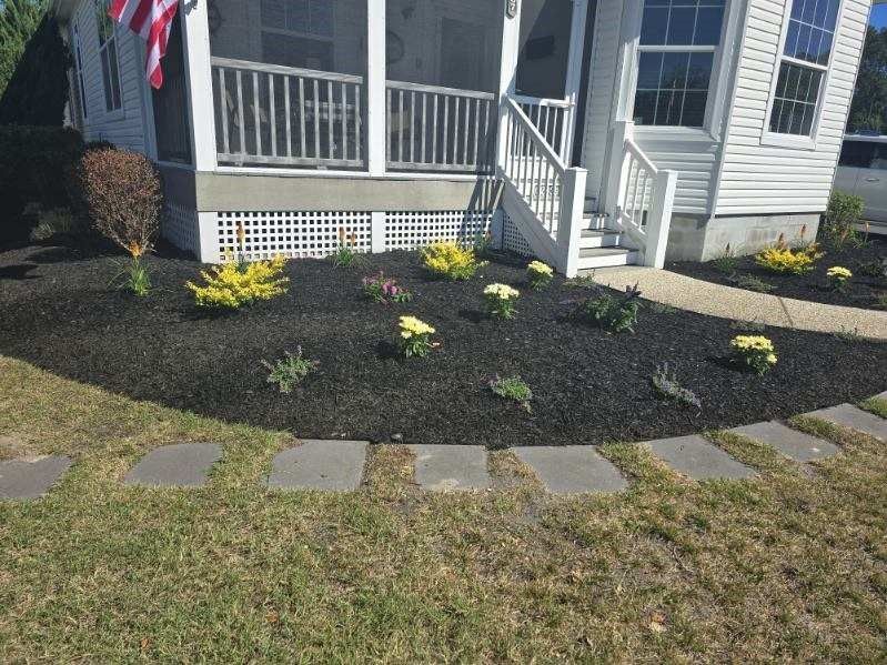 A house with a screened in porch and a walkway in front of it.