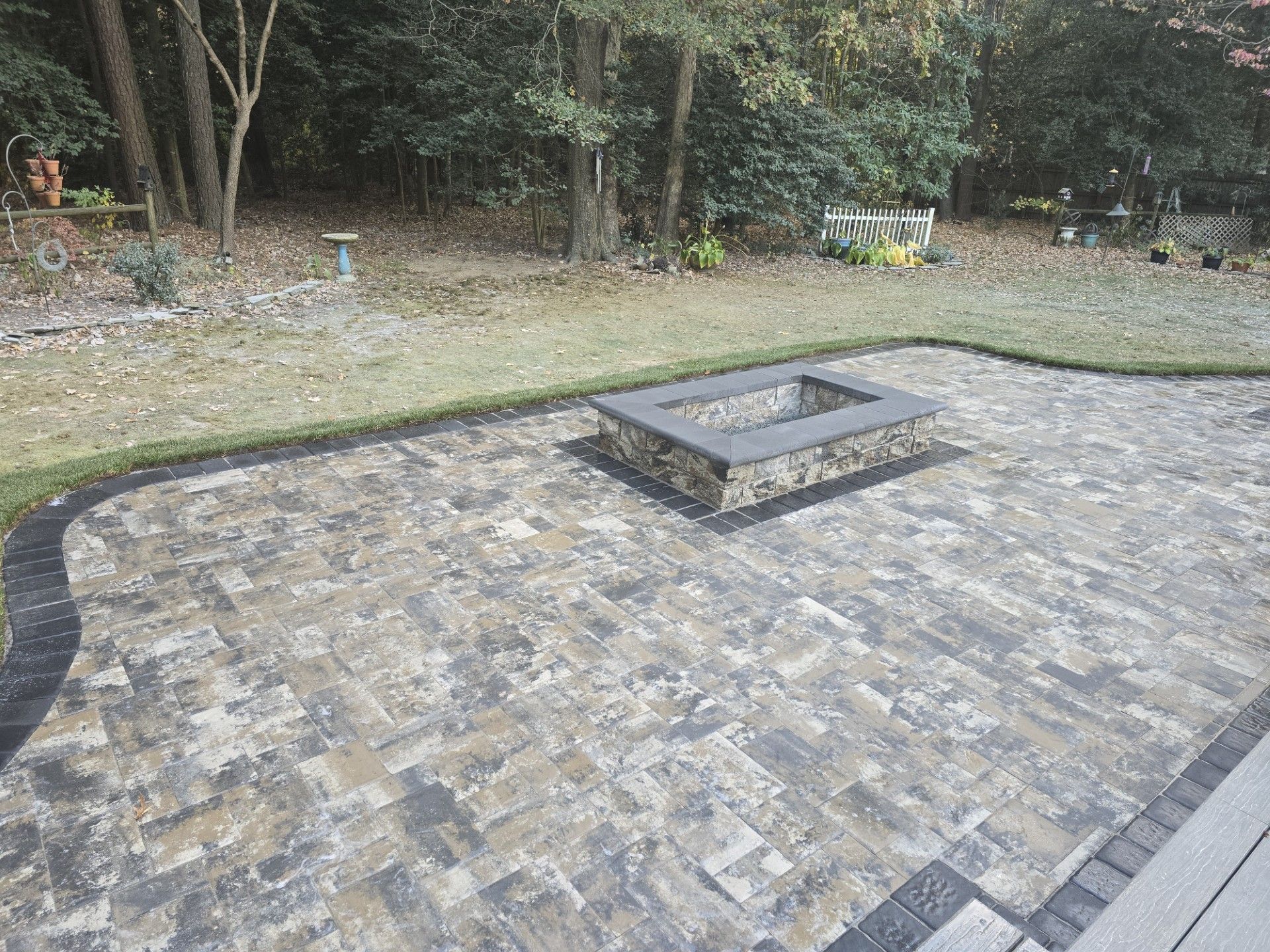 There is a fire pit in the middle of the patio.