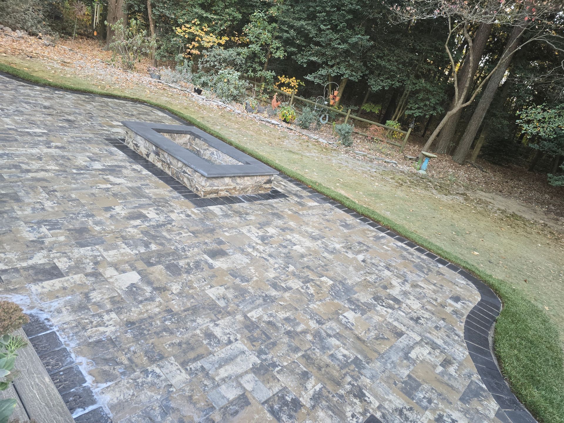 There is a fire pit in the middle of the patio.