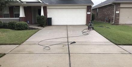 A clean driveway of a house after power washing