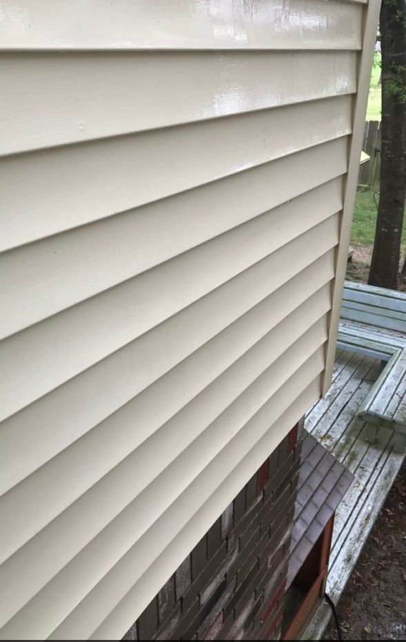 A white siding of a house after pressure washing