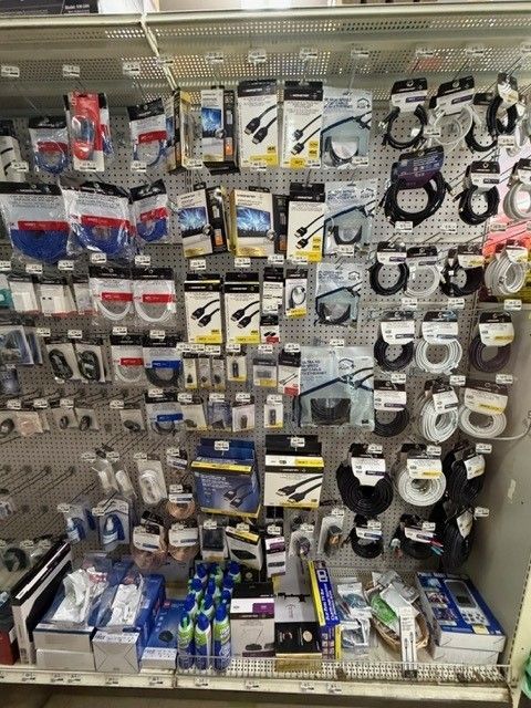 Assortment of electronic cables and accessories on display in a store.