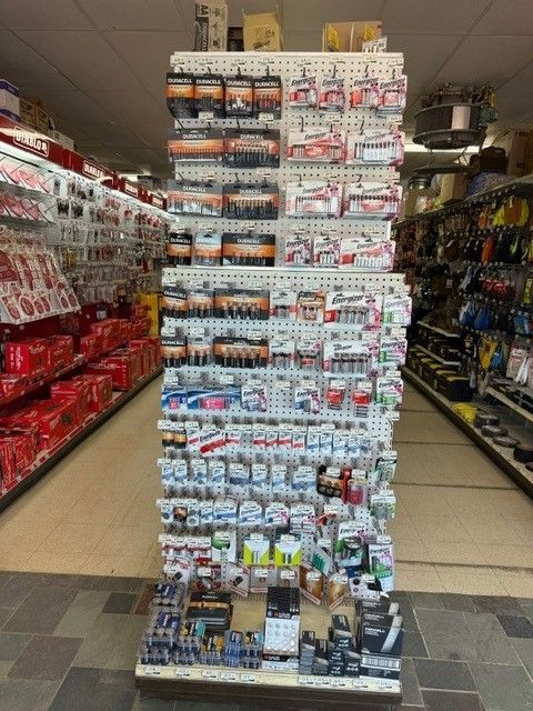 Aisle display in a hardware store showcasing a variety of small parts and accessories.