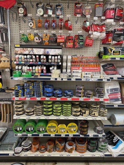 Shelves stocked with various hardware and automotive supplies at a retail store.