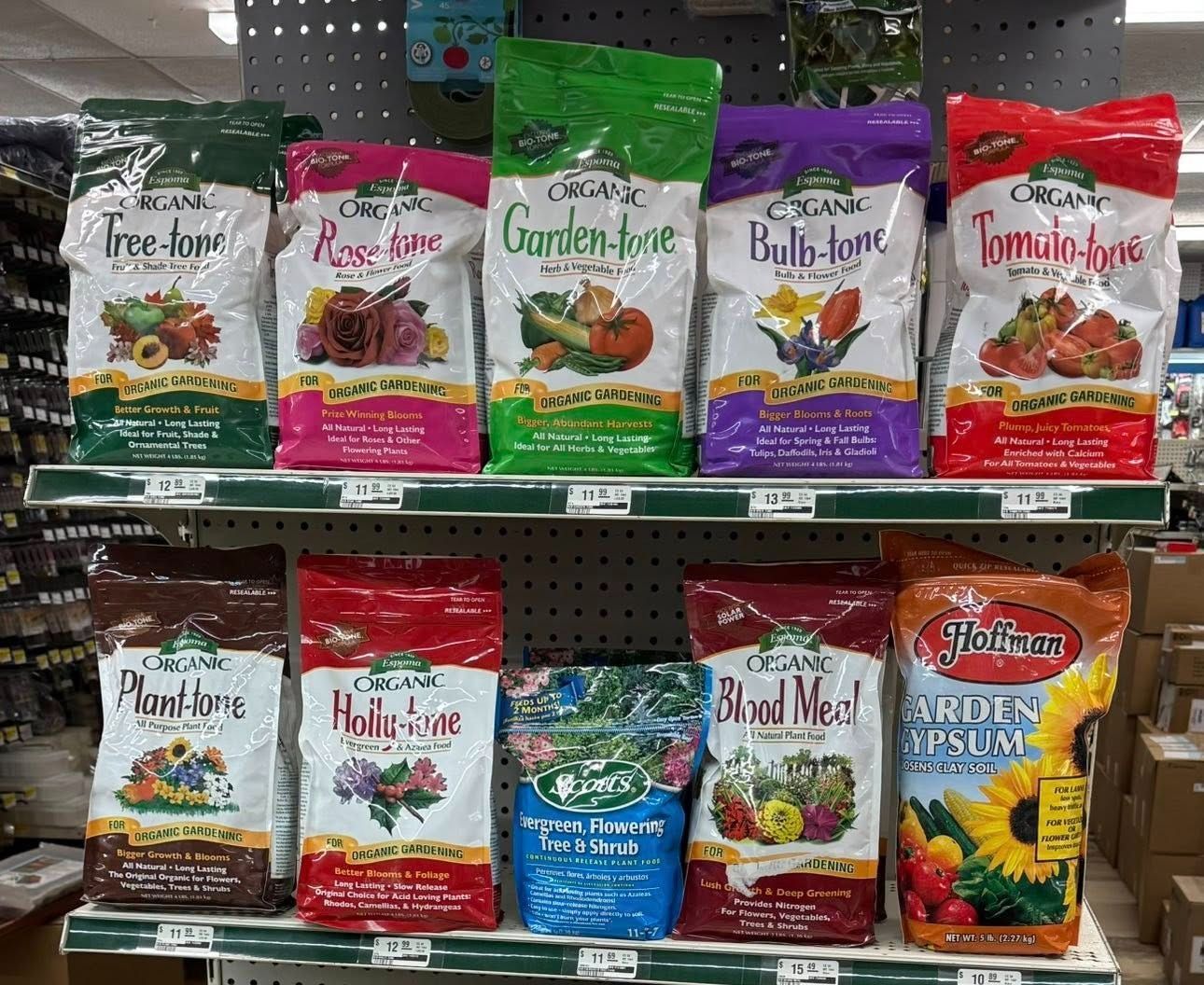 A shelf filled with bags of fertilizer in a store.