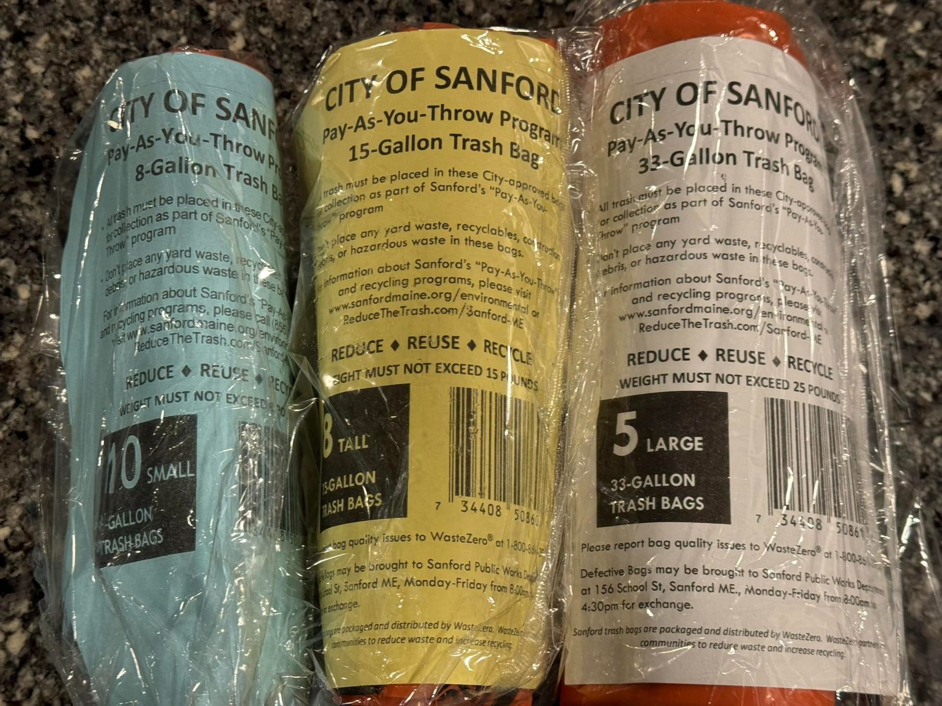 Three trash bags from the city of sanford are wrapped in plastic