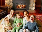 Happy family in front of fireplace