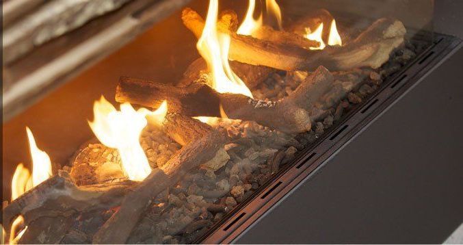 A fire on a log inside the fireplace