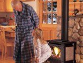 a child with her grandfather on front of the fireplace