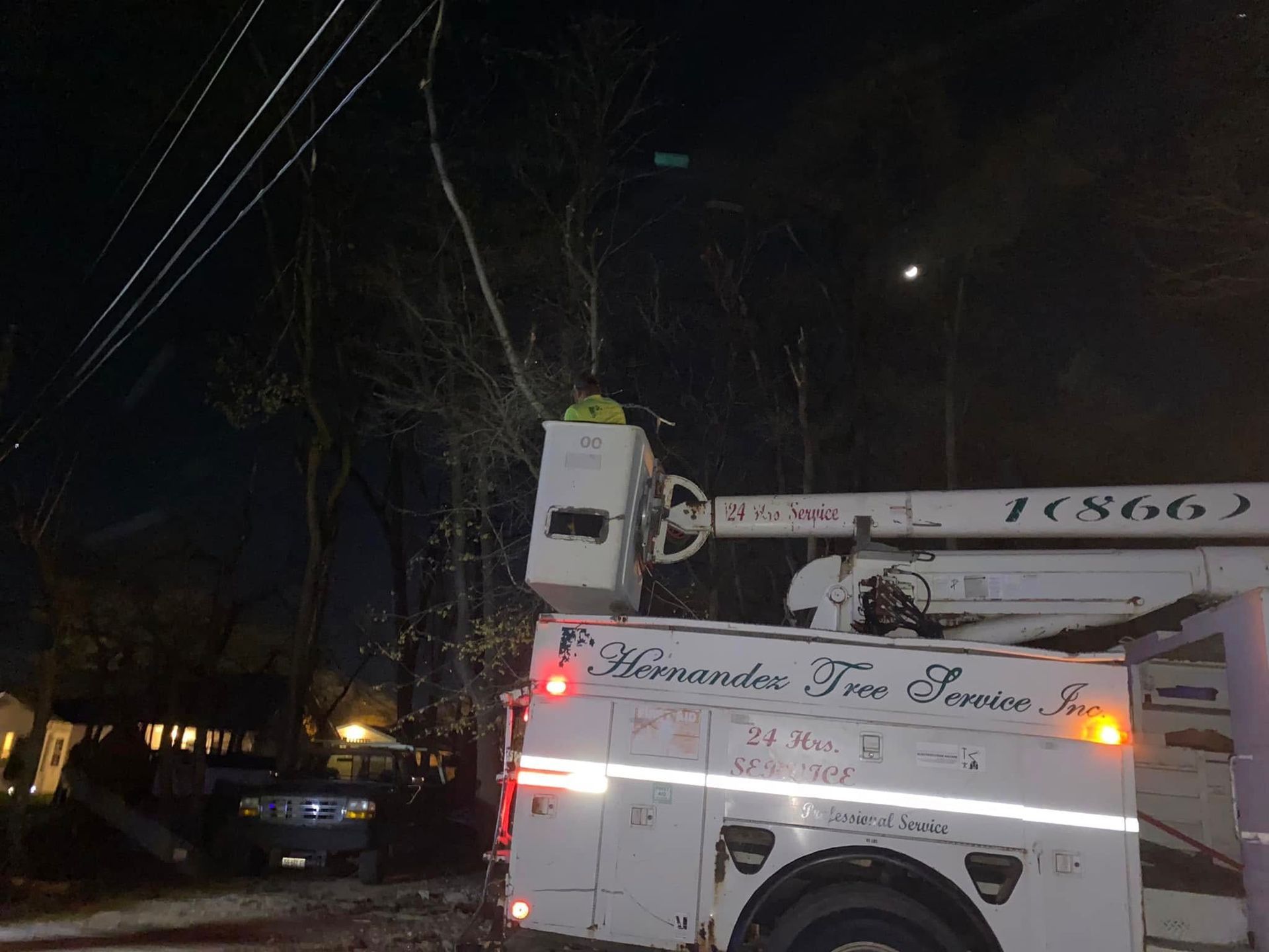 A white truck with a crane on the back of it