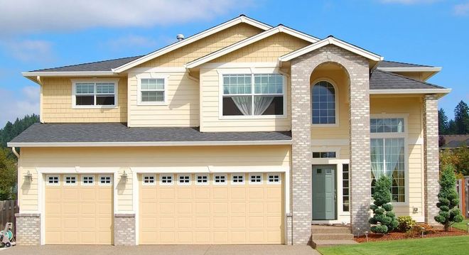 Two-story beige suburban house with three-car garage, arched entry, and white trim.