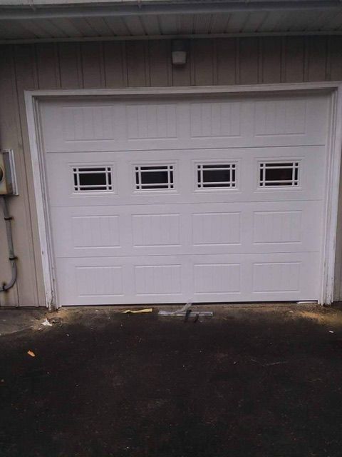 Garage with wide, long nicely paved driveway