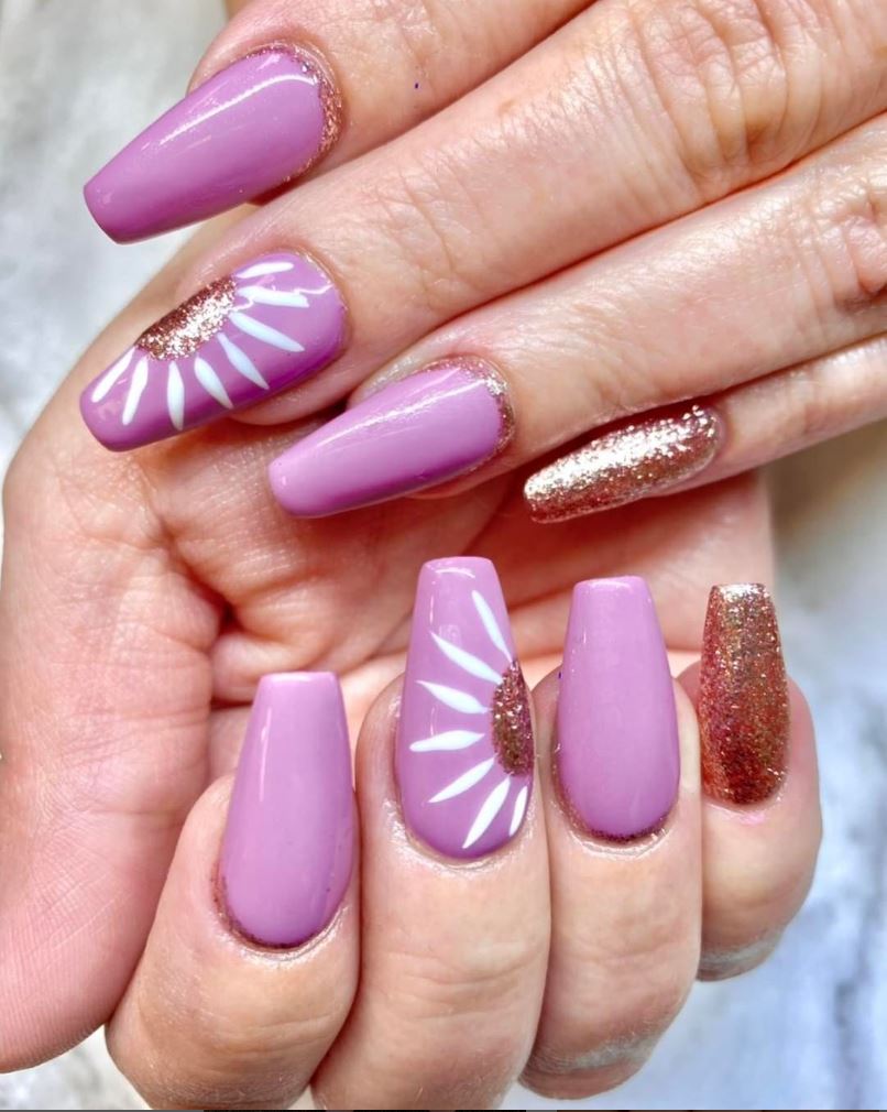 A close up of a woman 's hand with purple nails