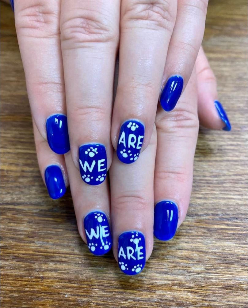 A close up of a person 's nails that say we are
