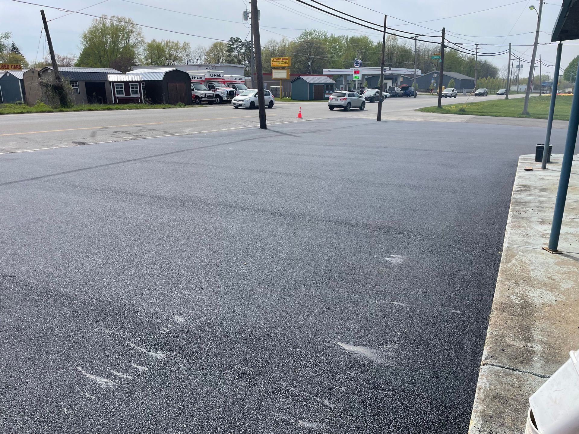A car is driving down a street in a small town.