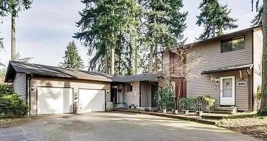 Tan duplex, with dark trim. 3-bedroom, 1.5 bath townhouse, single car garage. Puyallup, South Hill
