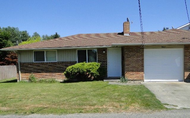 Tan duplex, with brick. 2-bedroom, 1  bath, single car garage. Puyallup