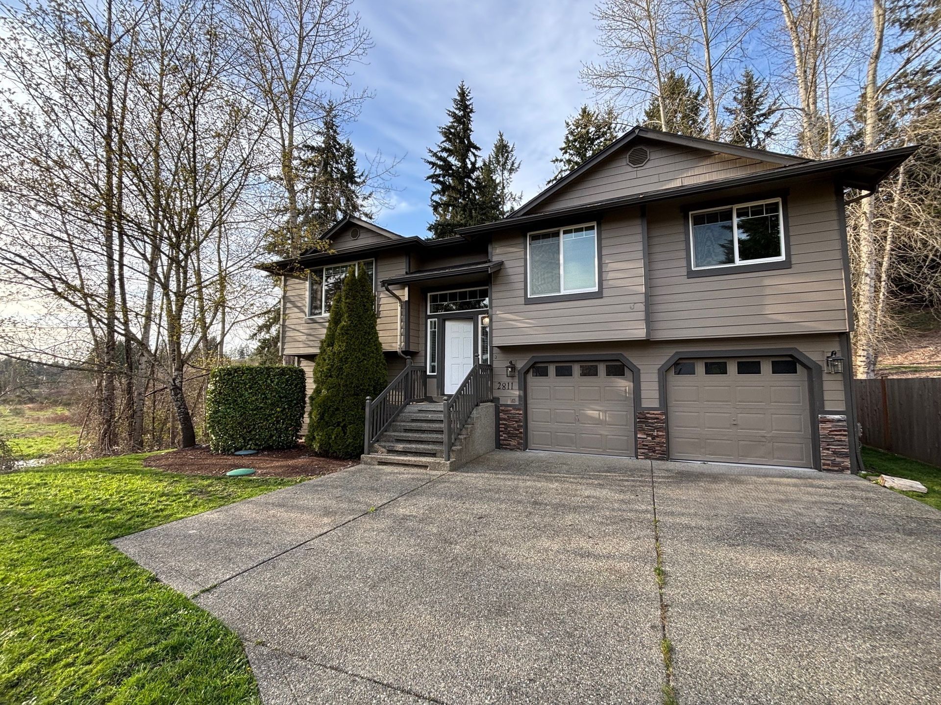 Two story tan house with brown trim