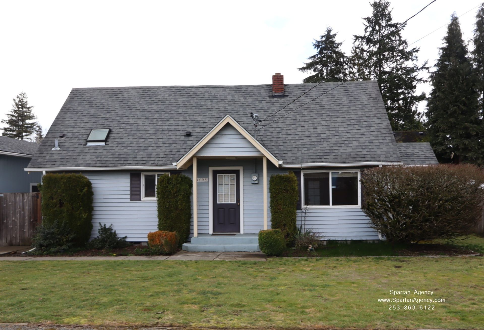 Light tan house and white trim , tree in front yard