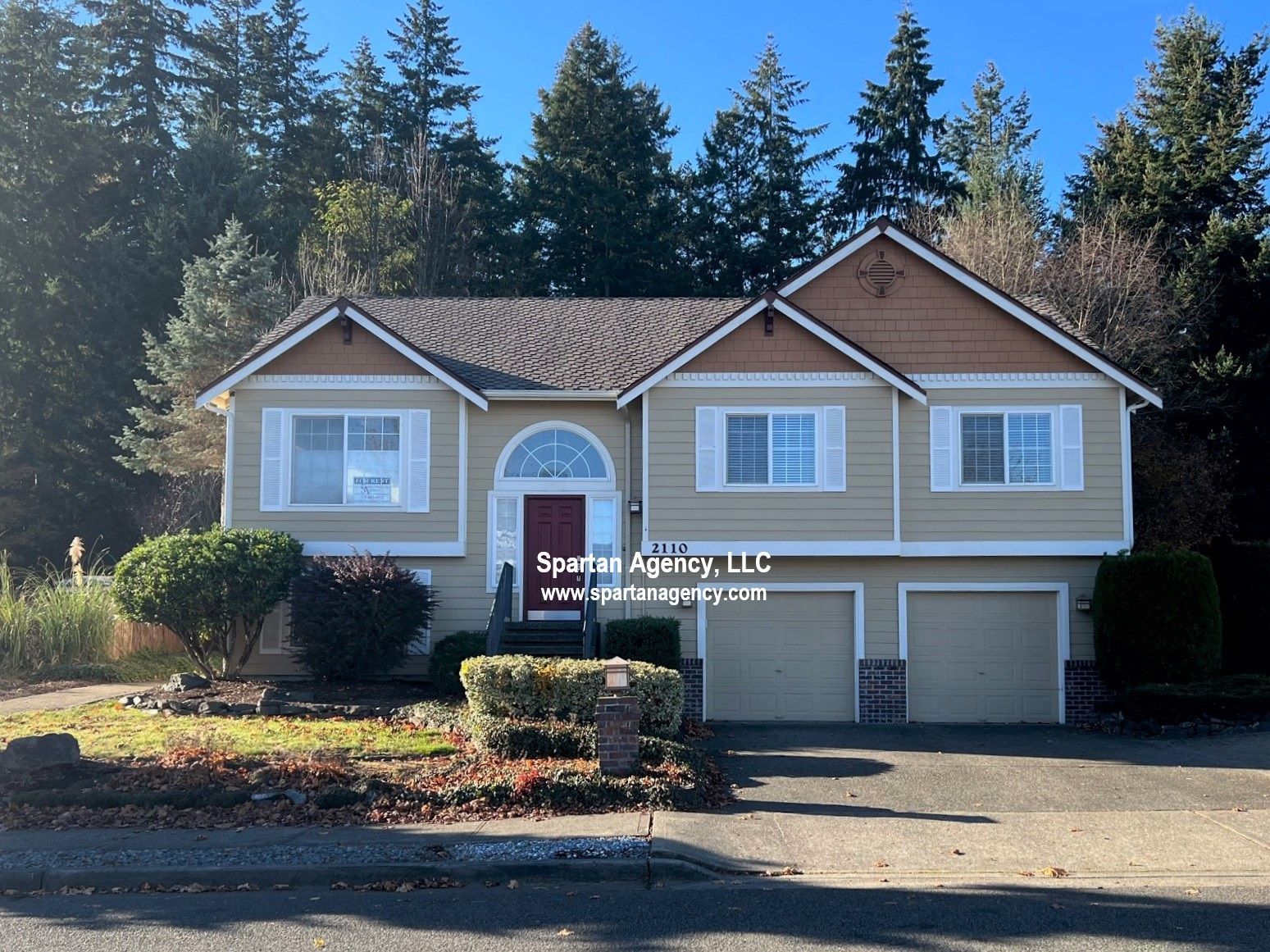 Two story cream house with white trim