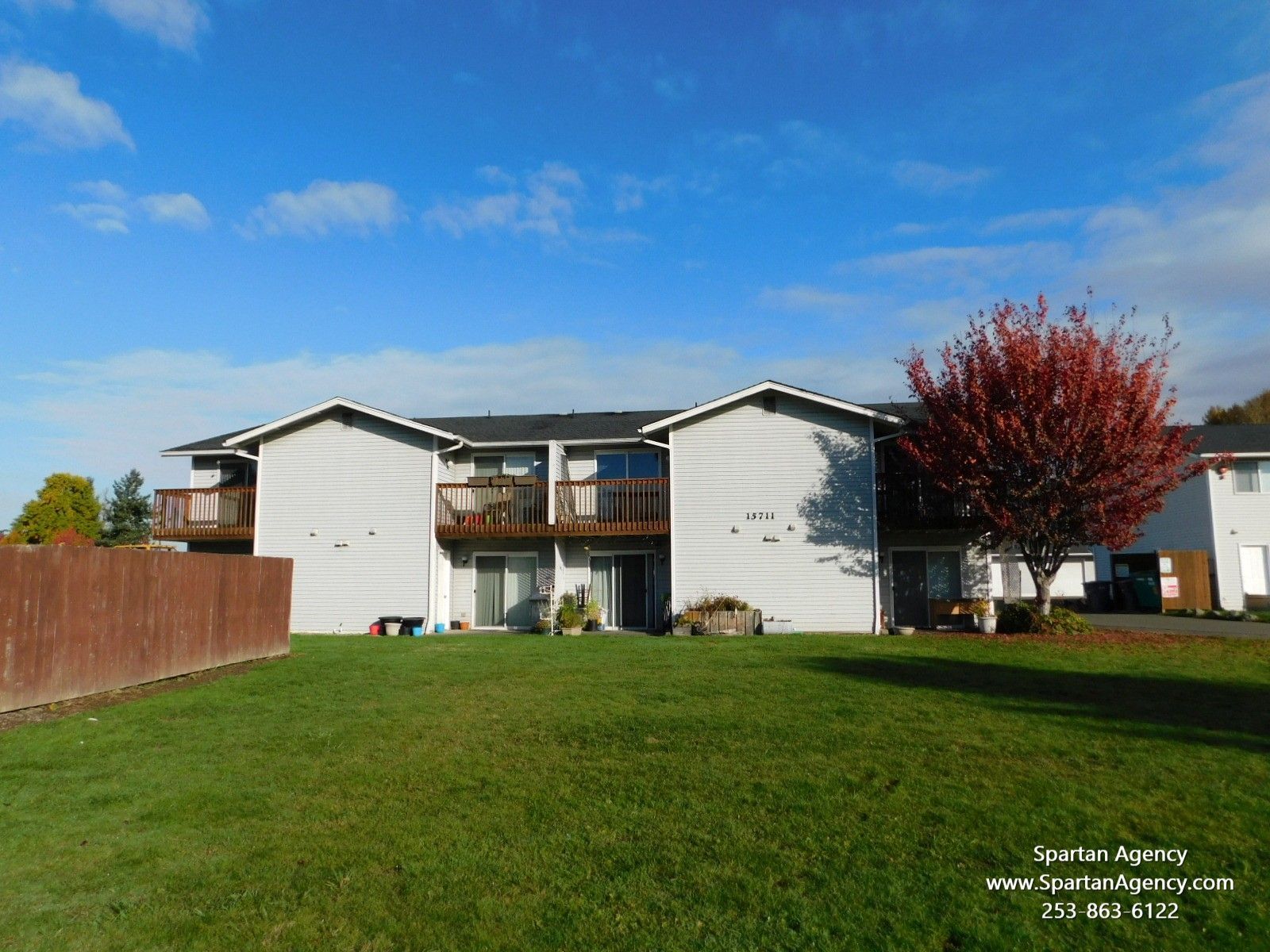 A house with a large lawn in front of it