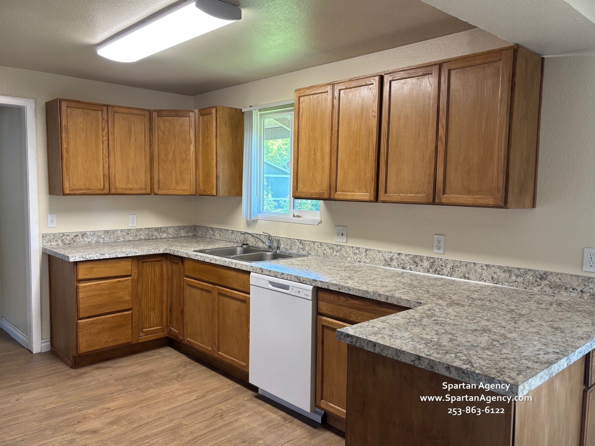 A kitchen with wooden cabinets and granite counter tops