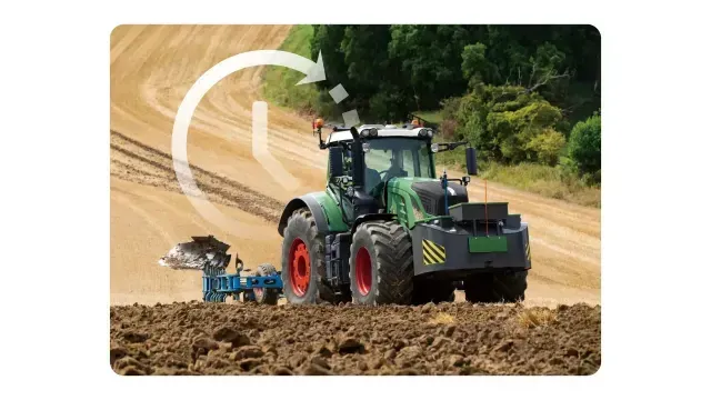 A green tractor plowing a field. A curved arrow shows the plowing path.