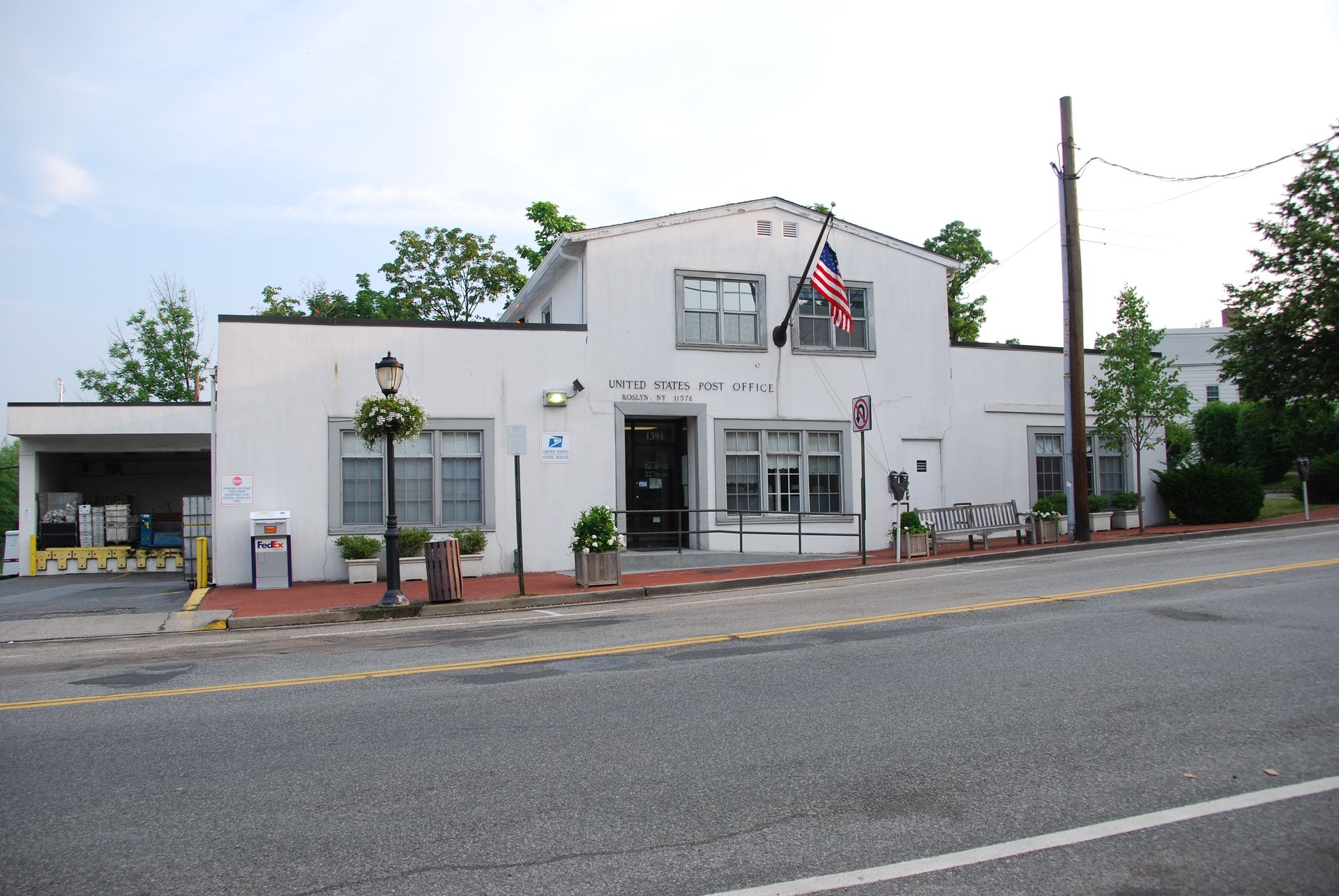A white building with an american flag in front of it
