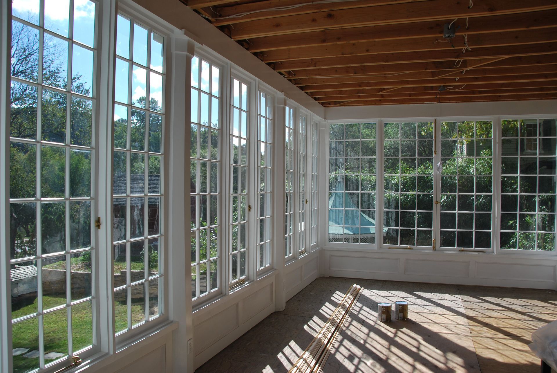 A room with lots of windows and a wooden ceiling