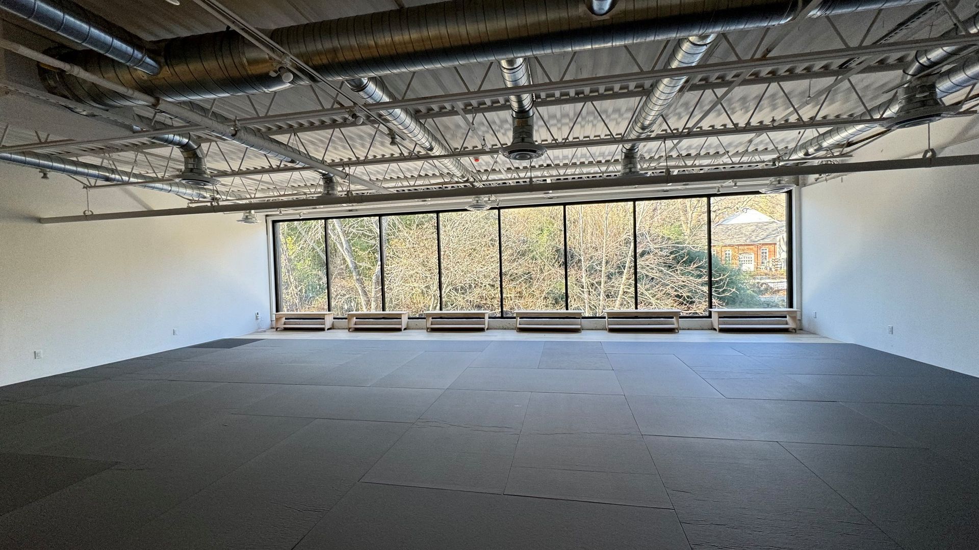 A large empty room with a lot of windows