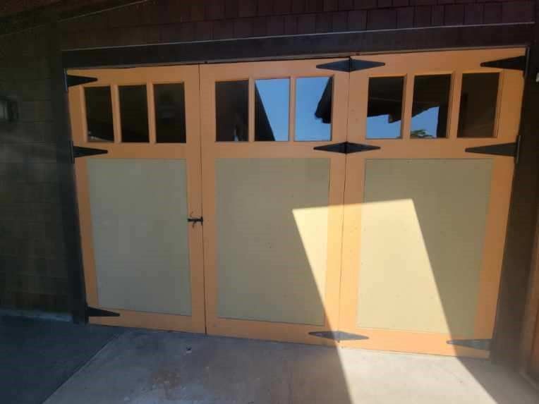 a wooden garage door with a lot of windows