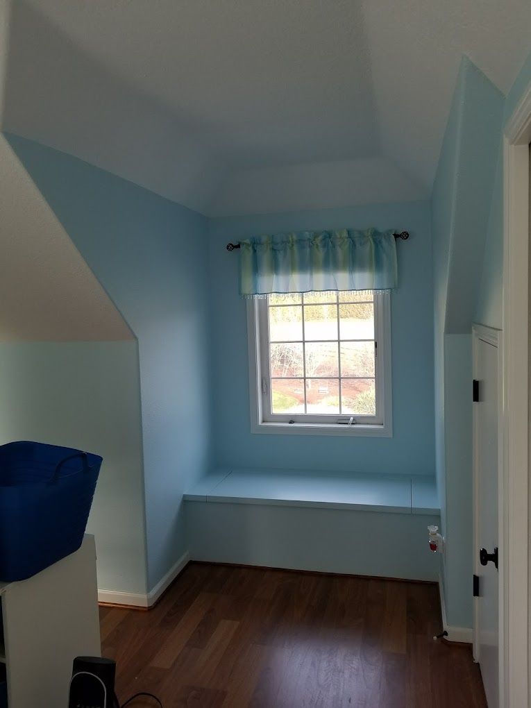 A room with blue walls and a window.