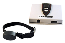 A black pet training collar next to a white Pet Stop®  transmitter box.