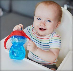 Baby holding water bottle