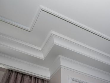 White crown molding on a ceiling, creating a layered, decorative border