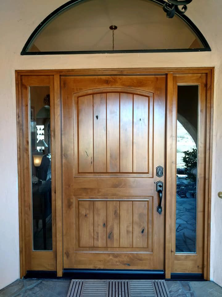Wooden front door with sidelights and arched transom