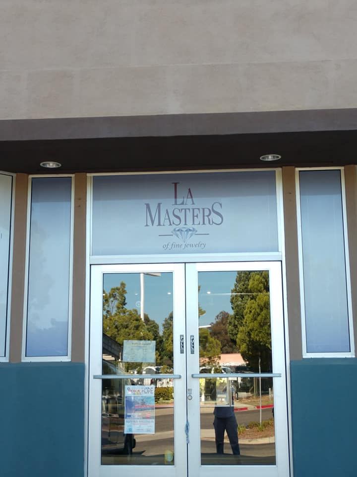 Entrance to LA Masters, featuring double glass doors, frosted glass panels, and signage.
