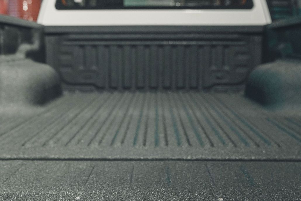 Sprayed-on bed liner in the back of a pickup truck